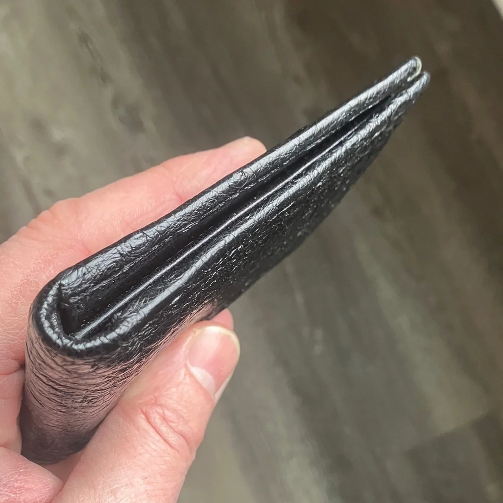 black bifold wallet made from genuine ostrich leather.
